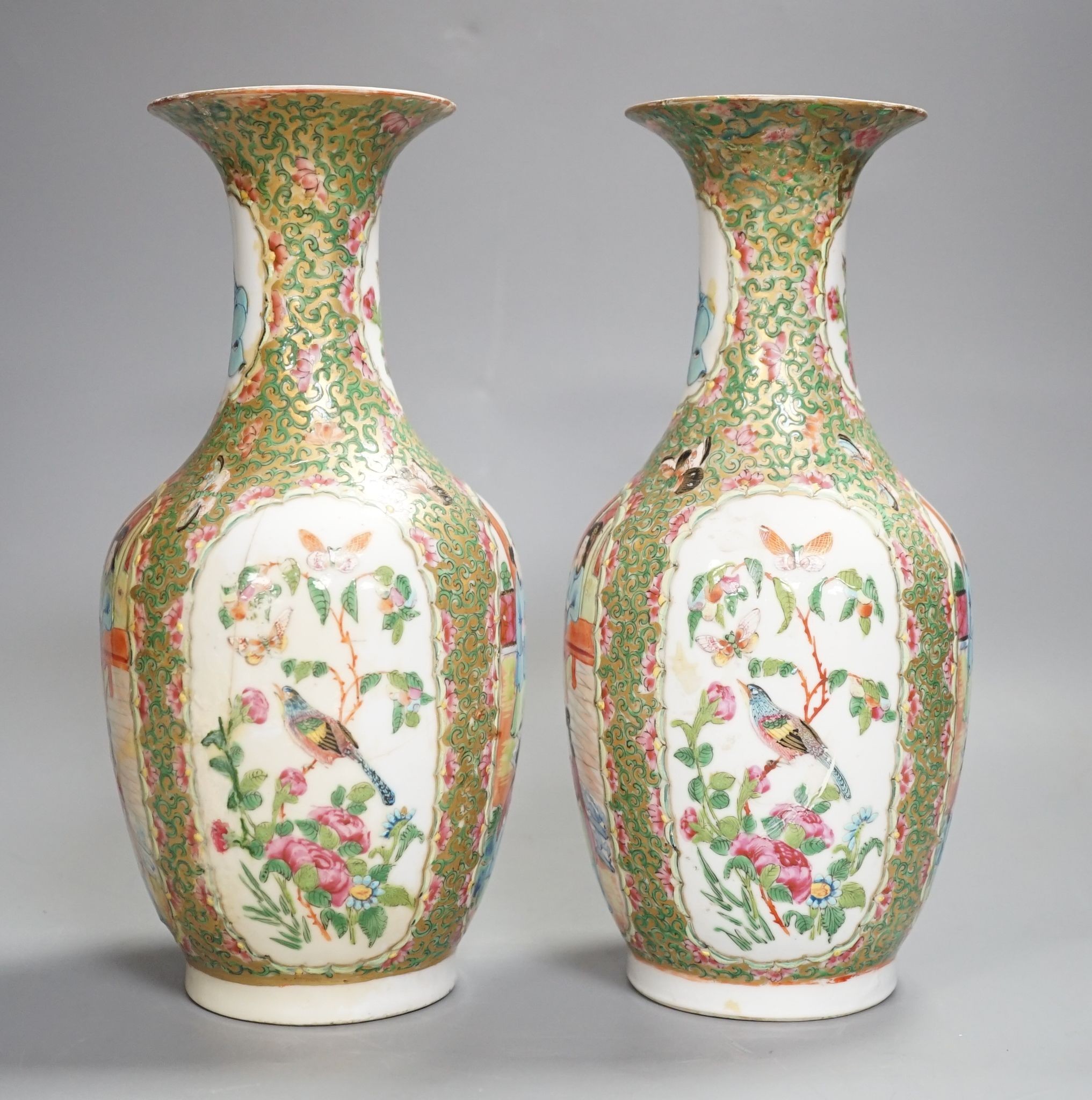 A pair of 19th century Chinese famille rose vases, 24 cms high.